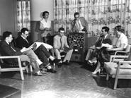 Robert Butler (age 28) seated to the left of tape recorder, discusses findings of the landmark Human Aging Study at the National Institute of Mental Health in 1955.