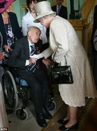Henry Allingham (aged 111) meeting Queen Elizabeth at the Buckingham Palace Garden Party in 2007.