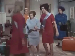 The West German chaperone (center) escorting her charge.