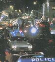 Ecto-1 and crowd outside 550 Central Park West set, seen in Ghostbusters Storybook page 46