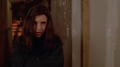 Vlcsnap-2025-09-26-14h02m52s217.png (1.56 MB) Brigitte looks at the bedroom door. Far behind her at the end of the basement corridor we see canned food.