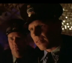 Two other policemen face Pamela at the Halloween party.