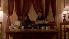 Vlcsnap-2025-09-25-20h33m54s906.png (1.96 MB) Brigitte and Pam on the couch in front of the bay window. Ginger sits on another couch to the right.