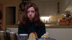 Vlcsnap-2025-09-25-21h01m01s757.png (1.66 MB) Kitchen seen from the breakfast area. Note the half-obscured fridge behind Brigitte and the open door to the basement.