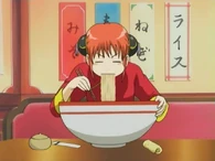 Kagura eating a big bowl of ramen in Episode 8