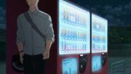 Akihiko hiding behind a vending machine