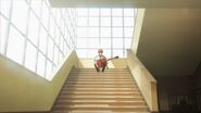 Mafuyu sitting on the stairs with his guitar