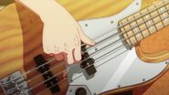 Haruki strumming his bass