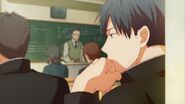 Ritsuka with his hand resting on his chin in class