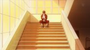 Ritsuka sitting on the steps alone at sunset