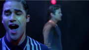 Blaine singing  with  in the auditorium.