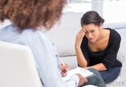 Woman-with-hand-on-her-head-on-couch-talking-to-therapist