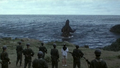 A weakened Godzilla retreats to the sea