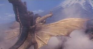 Gorosaurus usando la patada del canguro contra King Ghidorah