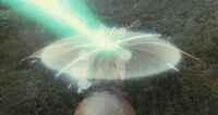 Grand King Ghidorah's force barrier repelling Mothra's Mineral Chest Beam