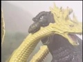 Godzilla bites on King Ghidorah's neck