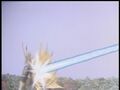 Gigan is hit from behind by the ray