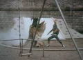 Greenman fighting Stock near a swingset
