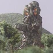 Hedorah walking through a forest on Godzilla Island