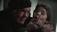 Mama Fratelli threatening to cut off Mouth's tongue.