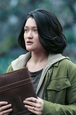 Margot holding Biddle's scrapbook