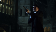 Penguin pointing his gun at Jim Gordon and Theo Galavan