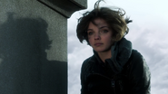 Selina Kyle perched in the cemetary following the funeral of Thomas Wayne and Martha Wayne.