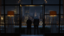 Jim Gordon and Carmine Falcone talking on Jim's balcony