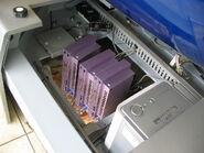 Three PS2 Fat models in Japan-only Sakura limited color scheme powering up the simulator and its three monitors.
