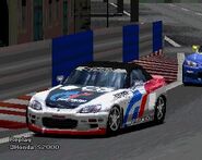 A Honda S2000 '99 with racing modifications applied. This is the first of the two racing schemes available. It comes in six color schemes: white, silver, black, red, yellow, and blue.