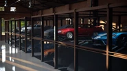 The interior of the Legend Cars building. Note that some cars shown here, such as the Porsche 911 Turbo (930) '81, Nissan Skyline GT-R V･spec II (R32) '94 and Ford GT '17 are not sold here despite being shown as part of pre-release footage.