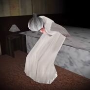 Slendrina's Mother is sitting on the bed in House of Slendrina.
