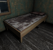 A bed with some blood on the blanket in bedroom 2