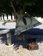 The Bill Cipher Statue with its broken off hat and the treasure chest at the police station.