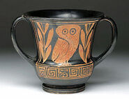 Athens, Greece, Ca 2nd quarter 5th century BCE. Super rare and wonderful pottery kantharos. Decorated in red-figure technique with owl looking forward standing between two laurel sprigs, Greek key along base