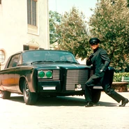 Bruce Lee as Kato posing alongside the Black Beauty from the TV series