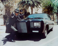 Van Williams (the Green Hornet) and Bruce Lee (Kato) pose with the Black Beauty in a publicity shot for the 1966 Green Hornet TV series.