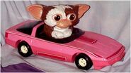 Gizmo drives around in his pink Barbie car.