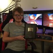 Grian with his Silver Play Button.
