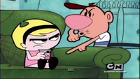 Billy pointing at Mandy with the yogurt