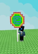 Rainbow Lollipop being held.