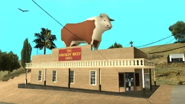 The Smokin' Beef Grill's building with the Large Cow.