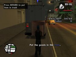 The player about to store the television inside of the van.