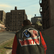 Pedestrian wearing an LC Wrath varsity jacket.