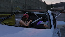 The passenger defending the player in their own vehicle.