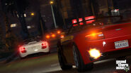 A 9F Cabrio racing ahead of a Rapid GT during Franklin and Lamar, seen in a pre-release screenshot.