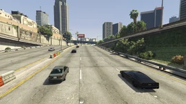 The racers proceed further into the city.