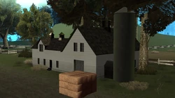 Front view of the farmhouse during the day.