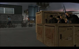 As the two parties approach each other, three hitmen take cover behind some boxes in a garage near the lot.