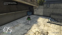 You will raise suspicion if you stay too long behind the police station and gain a Wanted Level.